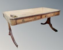 A reproduction mahogany regency style library table fitted with two drawers.