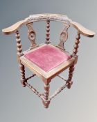 A 19th century carved oak corner chair.