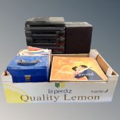 A box containing vinyl LPs and 7