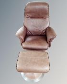 A Scandinavian brown leather revolving armchair with matching footstool.