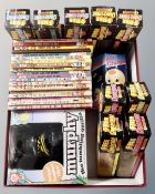 A box containing vintage Noddy books, Murphy tumbling gorilla, free to collect dinosaurs in packets.