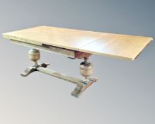 A continental oak refectory style dining room table with two extension leaves.