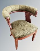 A 19th century mahogany armchair upholstered in green fabric.