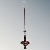 A Regency rosewood pole screen stand on paw feet converted to a standard lamp