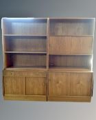 A continental two section storage unit comprising of a sliding door cabinet base and bookcase above,