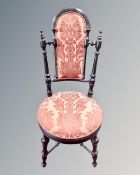 A 19th century ebonised single chair upholstered in two tone fabric.