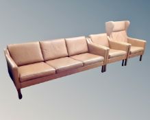 A Scandinavian three piece tan leather lounge suite comprising of a three seater settee (width