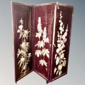 A three fold embroidered screen.