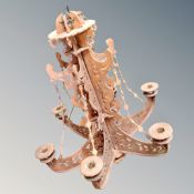 A wooden fretwork six branch chandelier.