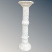 An alabaster torchère.