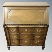 A 20th century Scandinavian shaped front writing bureau fitted with three drawers.