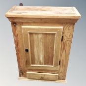 An antique pine wall cabinet fitted with a drawer.