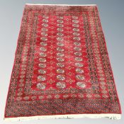 A Tekke rug on claret ground, Afghanistan, 176cm by 131cm.