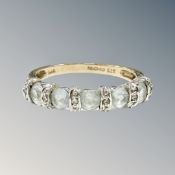 A 9ct yellow gold synthetic aquamarine half eternity ring, size N/O, 2.6g.