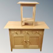 A Marks and Spencer furniture double door sideboard fitted with three drawers together with a