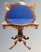 A Victorian rosewood serpentine fronted card table on four way pedestal