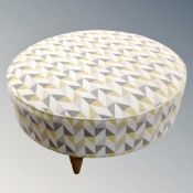 A contemporary circular footstool.