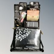 A basket containing seven sets of boxed Christmas lights.