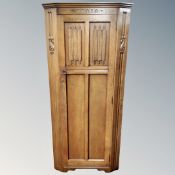 An oak linen fold hall wardrobe.