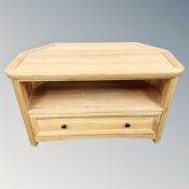 A contemporary oak corner TV stand fitted with a drawer.