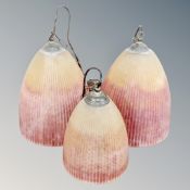 A set of three glass ceiling lights.