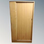 A mid-20th century teak gentleman's wardrobe with shutter door.