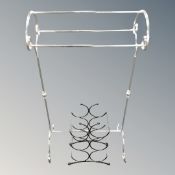A chrome metal towel rail together with a small wine bottle rack.