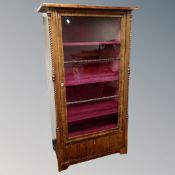 A 19th century Scandinavian glazed display cabinet with pink velvet interior