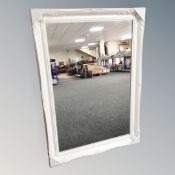 A 3' by 2' white swept frame mirror.