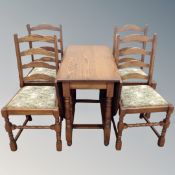 A Jaycee oak drop leaf table with four ladder backed chairs