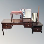 A Stag Minstrel five drawer knee hole dressing table with triple mirror and stool,