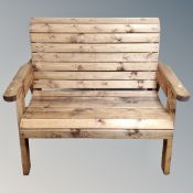 A pine wooden slatted garden bench