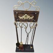 A Victorian style four piece companion set on stand