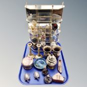 A brass and glass curio stand together with seven ceramic and metal decorative eggs and assorted