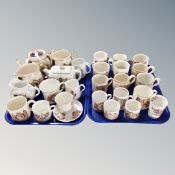 Two trays containing antique and later commemorative mugs, beakers, tankards, teapots etc.