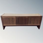 A 20th century Scandinavian triple sliding door sideboard on raised legs in oak finish