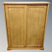 A contemporary pine sliding door cabinet