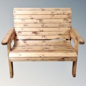 A pine wooden slatted garden bench