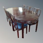 A Chinese style hardwood circular extending dining table with two leaves and six chairs