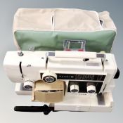 A New Home Combi 10 electric sewing machine with foot pedal and cover