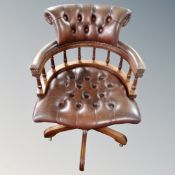 A brown buttoned leather Chesterfield desk chair