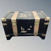 A Chinese ebonised camphor wood chest with brass fittings