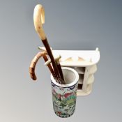 A Chinese style glazed pottery stick pot containing four walking sticks and crooks together with a