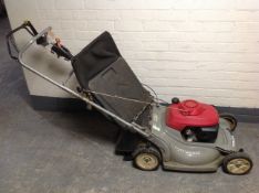 A Power Devil self drive petrol lawn mower.