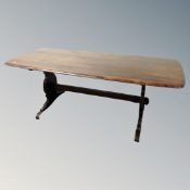 An Ercol stained elm and beech refectory dining table