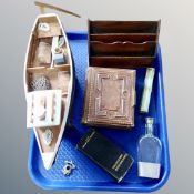 A tray containing an antique letter rack, a 19th century leather bound photo album,