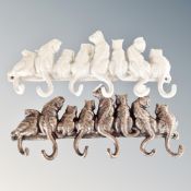 Two cast iron eight hook cat wall racks.