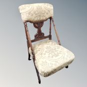 A 19th century beech nursing chair on A-frame legs