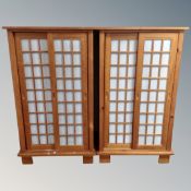 A pair of pine sliding door double door cabinets