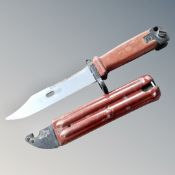 A 20th century bayonet with Bakelite grip and sheath.